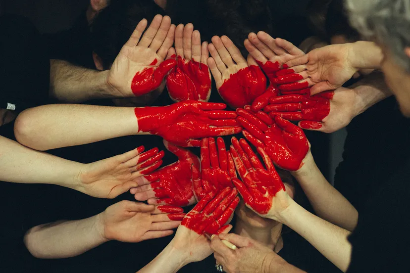 Regaining Buy In - Image of team members with a heart painted on their hands