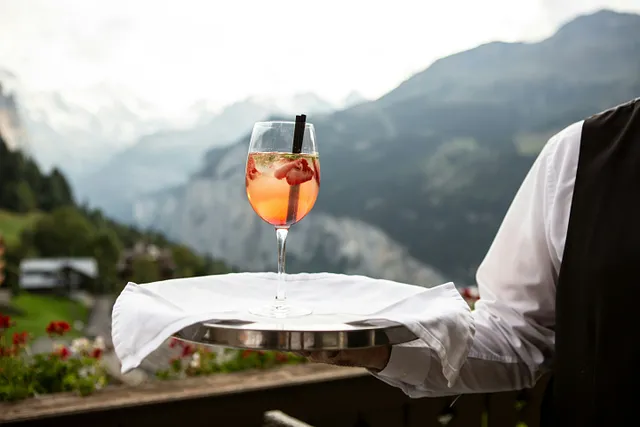 An image of a waiter serving a drink