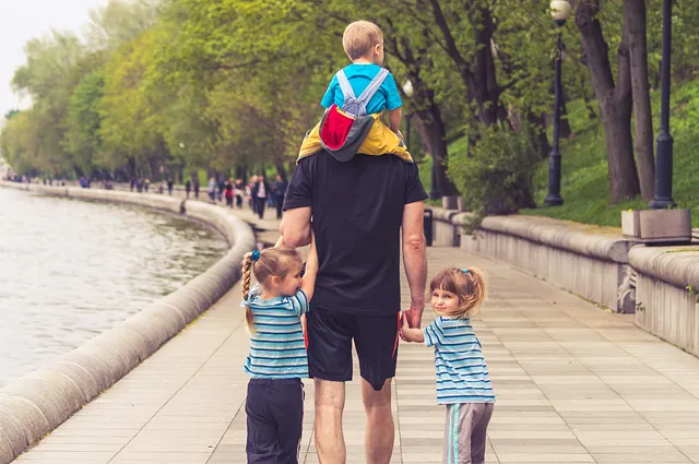 Man walking with his 3 kids