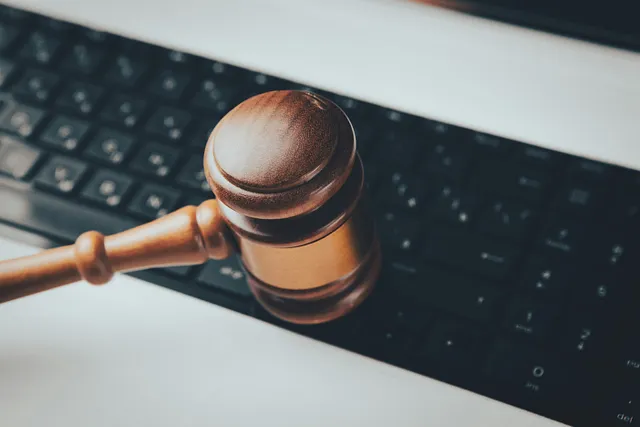 A judges gavel coming down on a keyboard as through affirming a final decision.