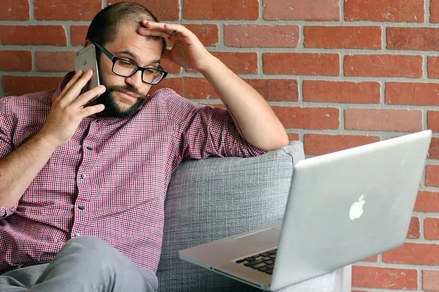 Stressed out man looking at his laptop